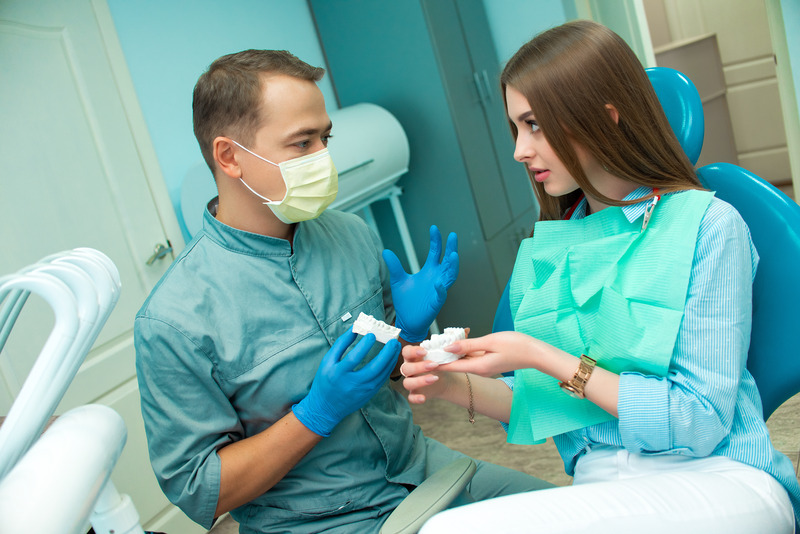 Patient talking to their dentist about a smile makeover